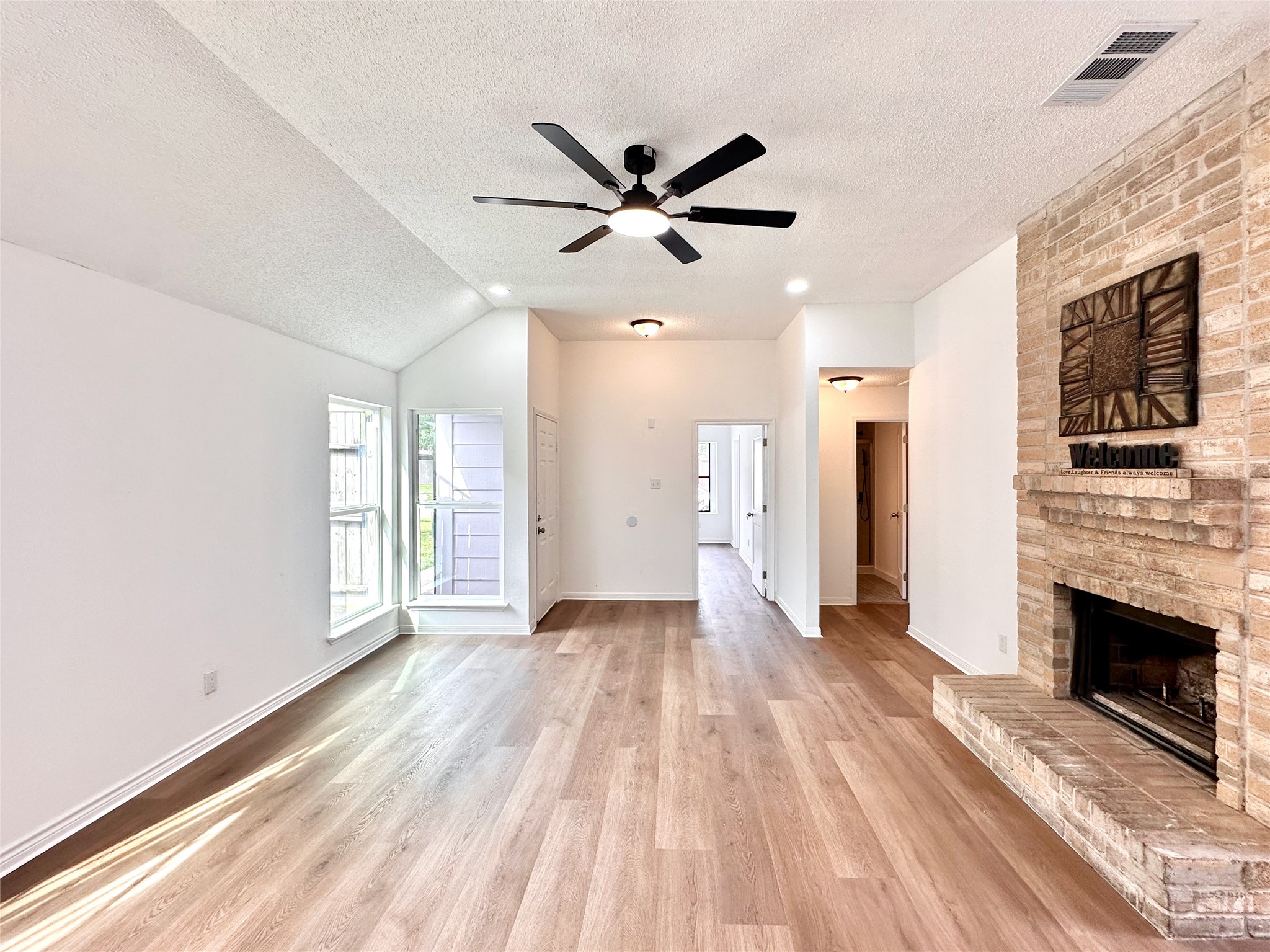 16411 Gold Ridge Lane Houston, TX 77053 - Photo 5 of 25 a view of an empty room with a fireplace and a window
