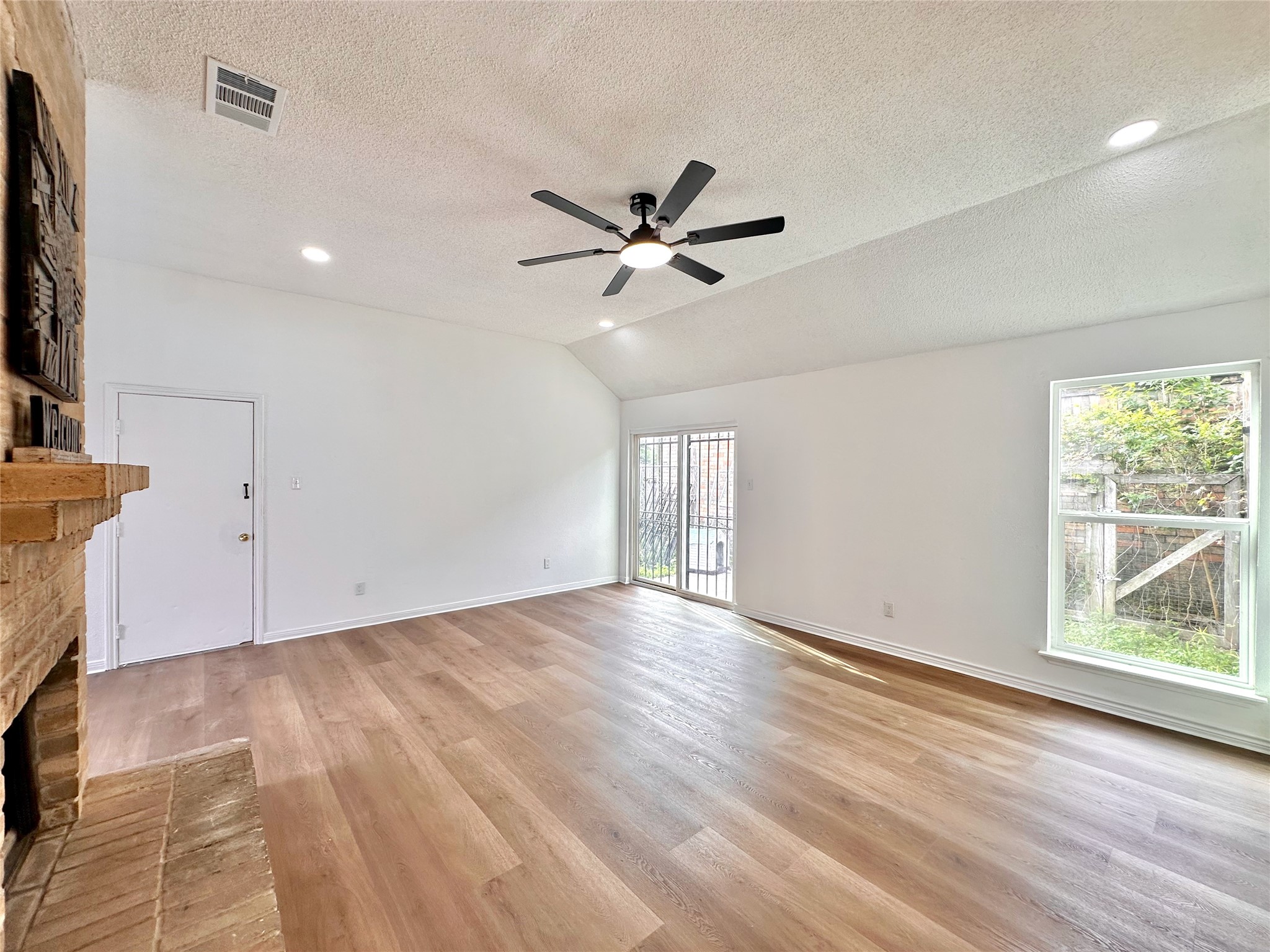 16411 Gold Ridge Lane Houston, TX 77053 - Photo 6 of 25 a view of an empty room with a window and wooden floor