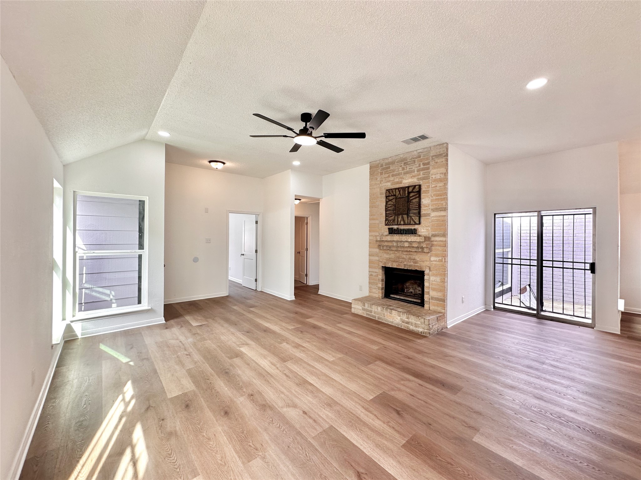 16411 Gold Ridge Lane Houston, TX 77053 - Photo 7 of 25 a view of a livingroom with a fireplace a ceiling fan and wooden floor