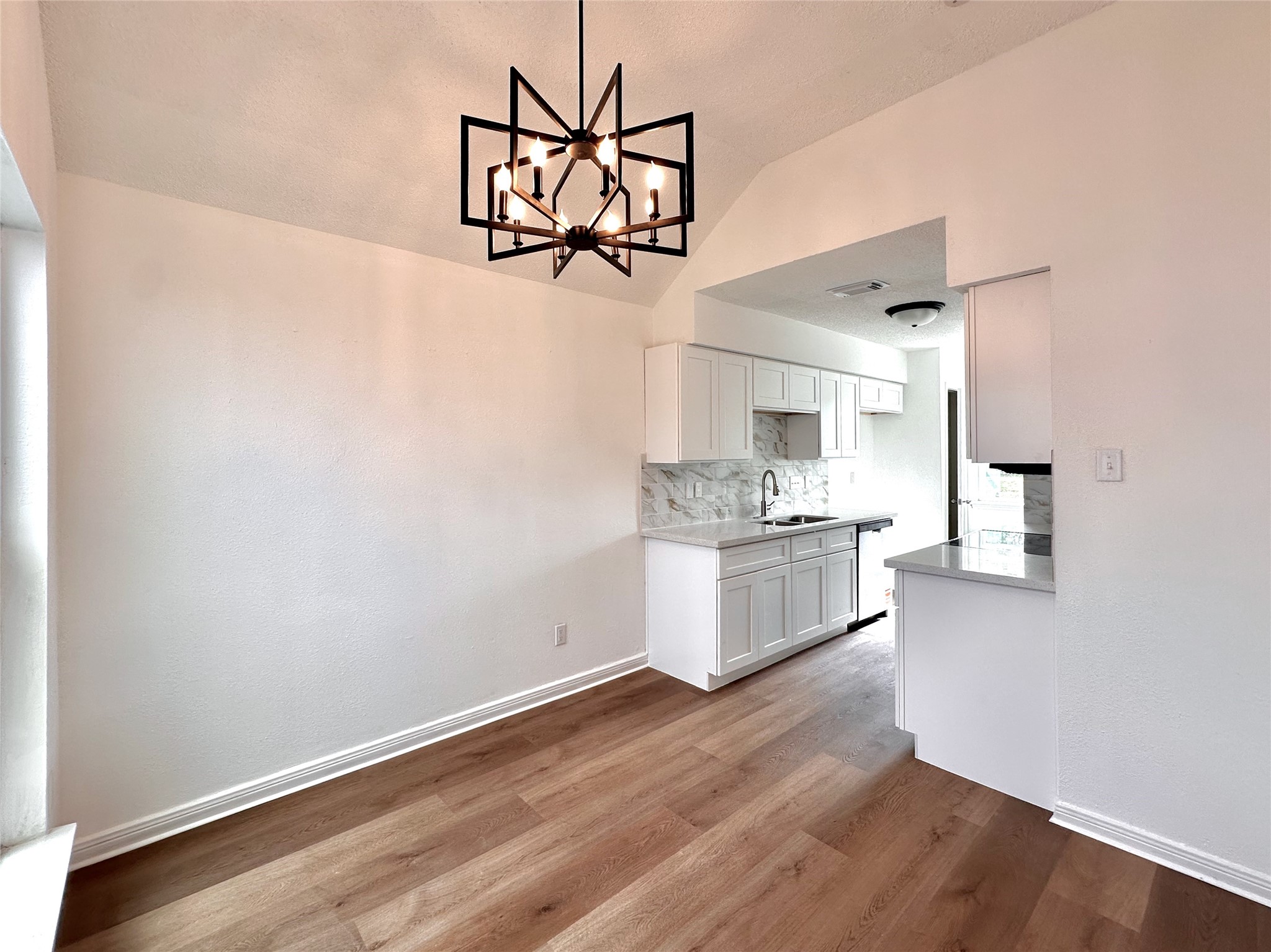 16411 Gold Ridge Lane Houston, TX 77053 - Photo 9 of 25 a kitchen with a refrigerator and white cabinets