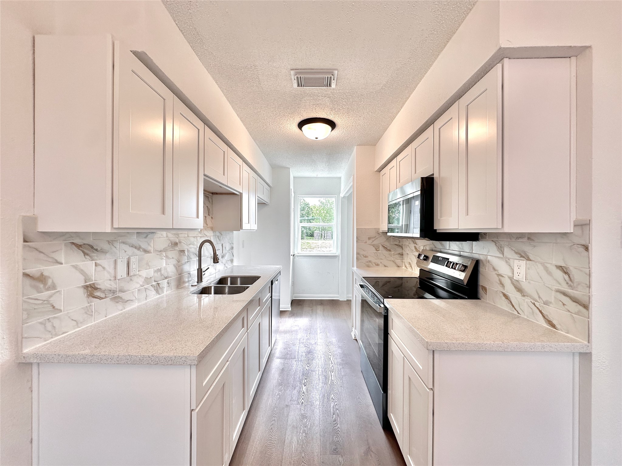 16411 Gold Ridge Lane Houston, TX 77053 - Photo 10 of 25 a kitchen with stainless steel appliances a sink a stove and cabinets