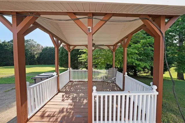 a view of a porch with wooden floor and outdoor seating