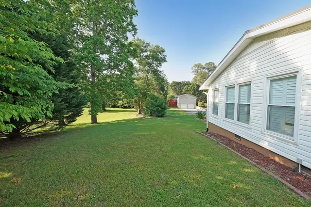 a view of a house with a backyard