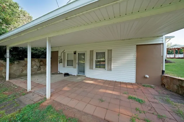 a view of a house with backyard porch and sitting area