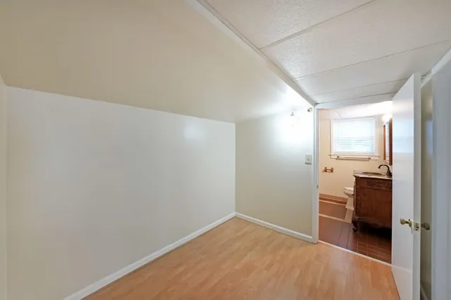 a view of hallway with a sink and a stove
