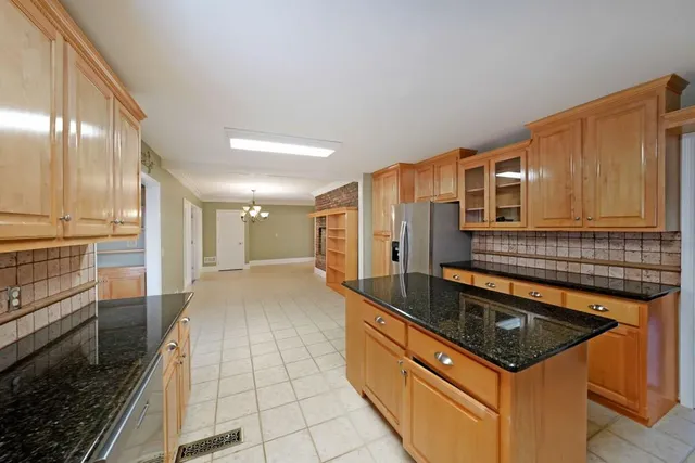 a kitchen with granite countertop a sink and cabinets