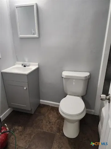 a white toilet sitting next to a bathroom sink