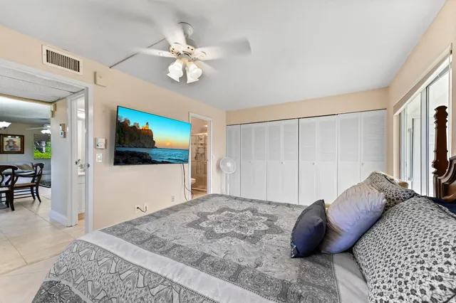 a bedroom with a large bed and a flat screen tv