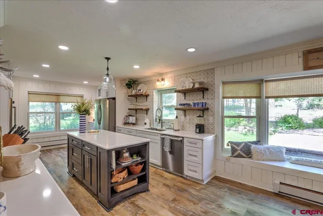 a kitchen with stainless steel appliances granite countertop a stove and a microwave