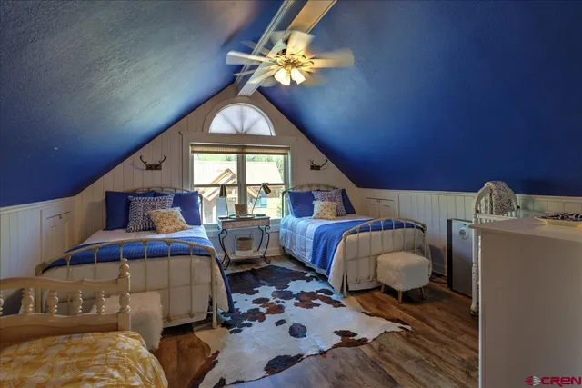 a spacious bedroom with a bed a couch and a window