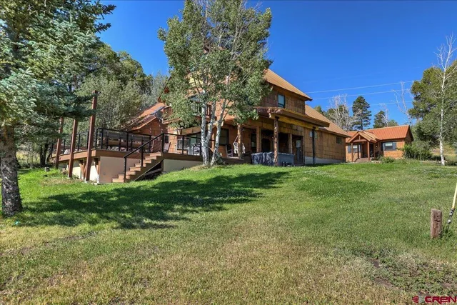 a view of a house with a yard porch and sitting area