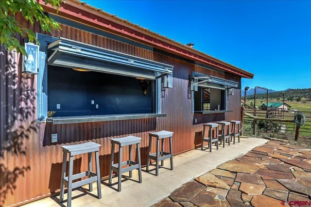 a kitchen with stainless steel appliances a sink and a large window