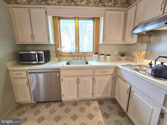 a utility room with sink dryer and washer