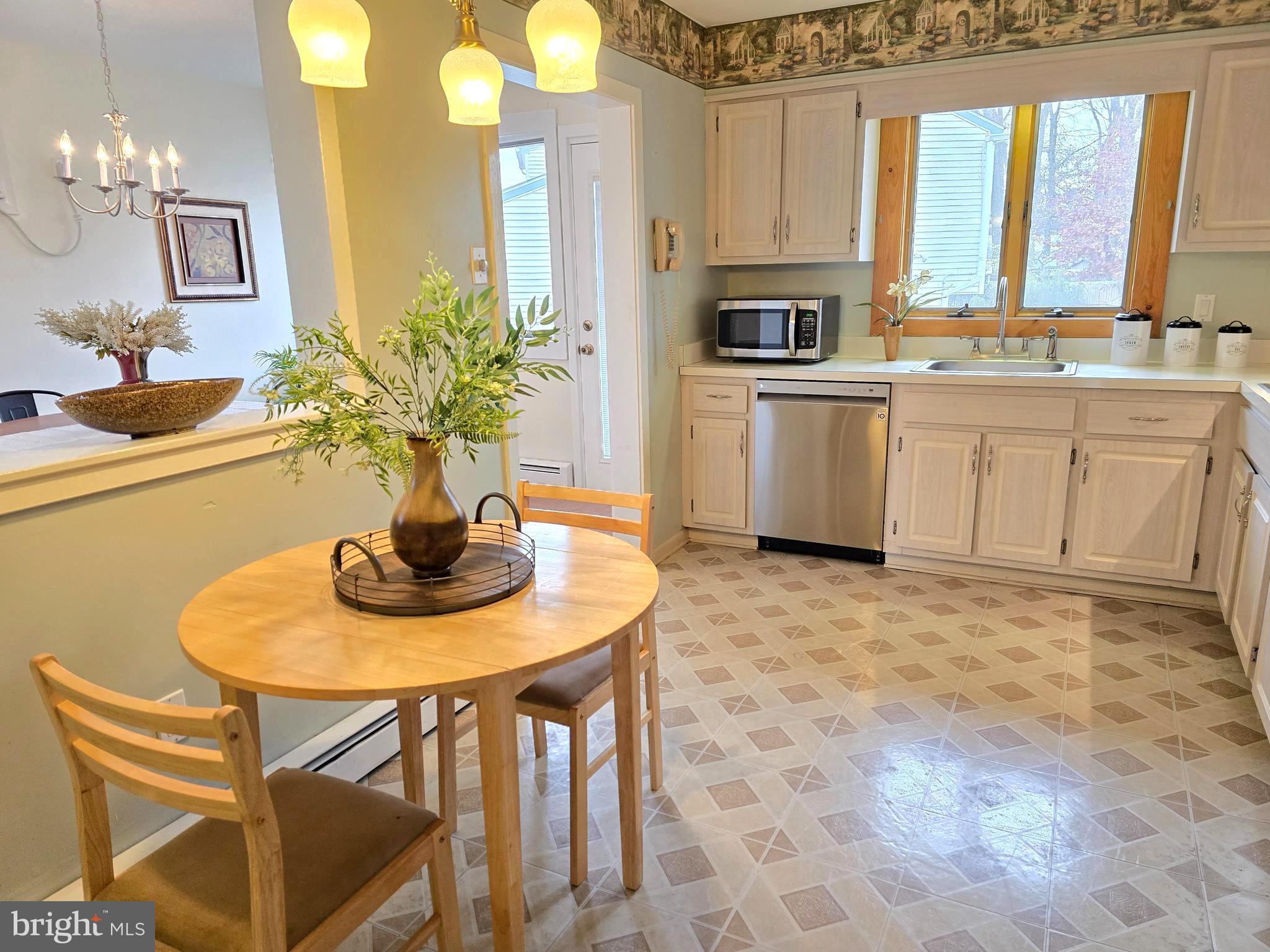 120 East Center Avenue Maple Shade, NJ 08052 - Photo 13 of 34 a kitchen with stainless steel appliances a sink a stove a table and chairs
