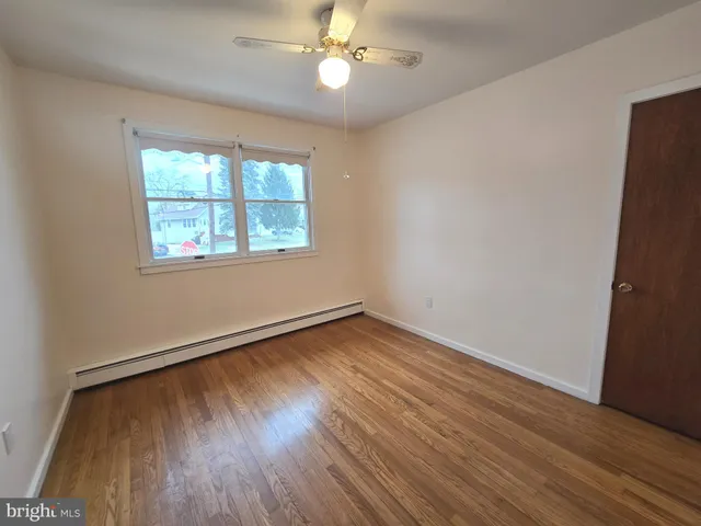 an empty room with wooden floor