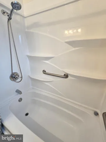 a view of house with a bench and floor to ceiling windows