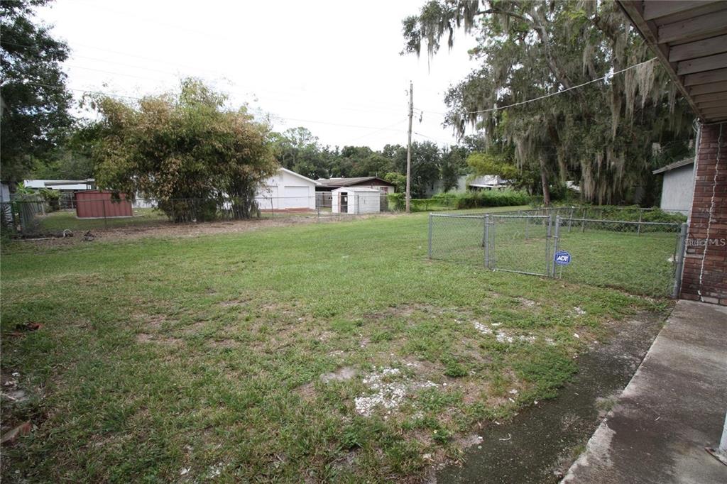 521 20th Street Southwest, Unit C Winter Haven, FL 33880 - Photo 16 of 18 a view of a house with a yard