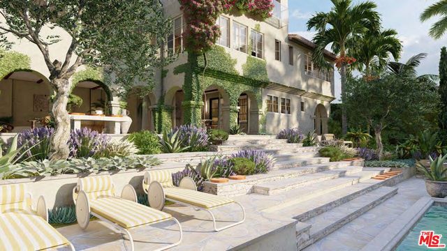 a front view of a multi story residential apartment building with yard and parking space