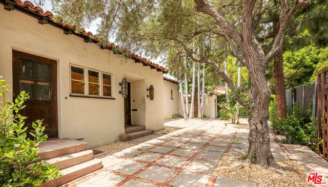 a view of a house with a tree in the background