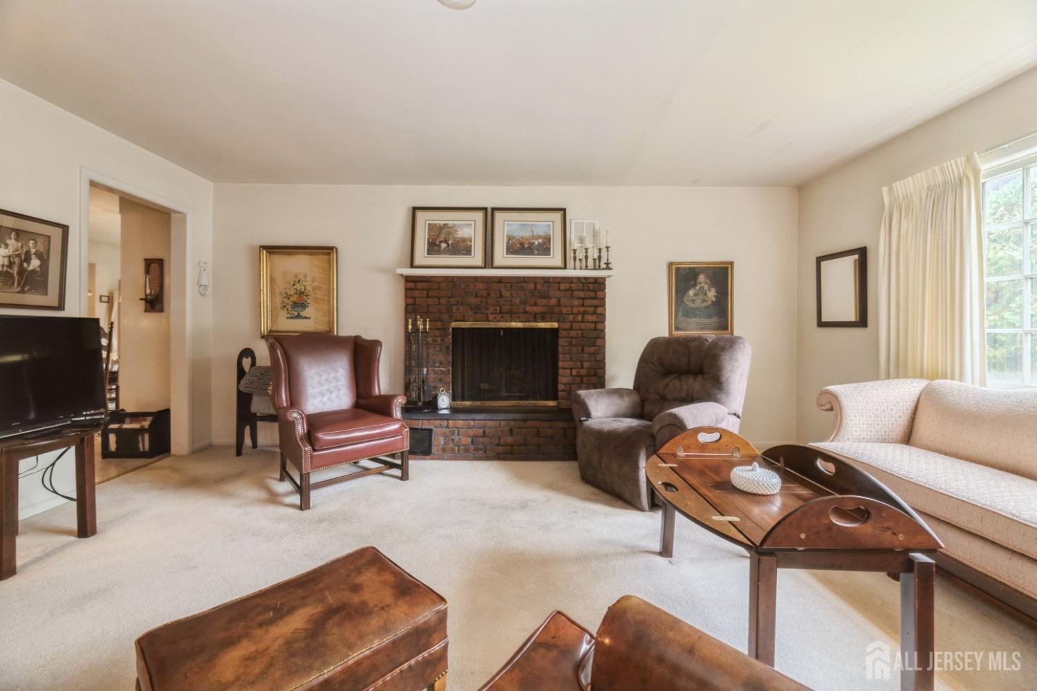 295 Dallas Road North Brunswick, NJ 08902 - Photo 14 of 40 a living room with furniture a fireplace and a flat screen tv