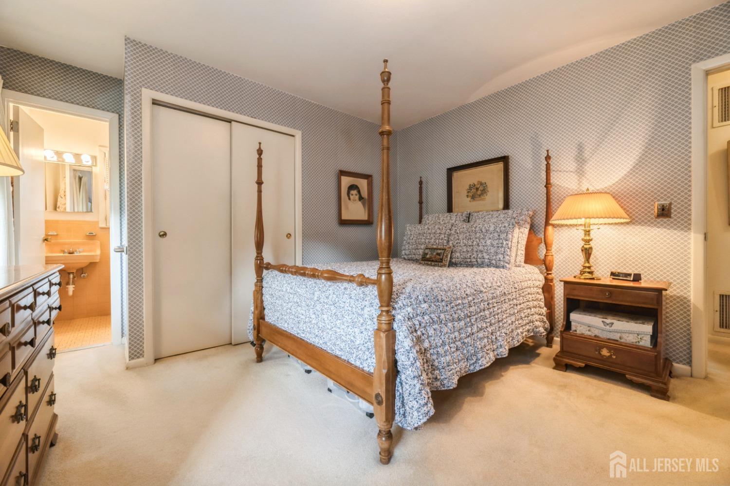 295 Dallas Road North Brunswick, NJ 08902 - Photo 17 of 40 a bedroom with a bed and a chandelier