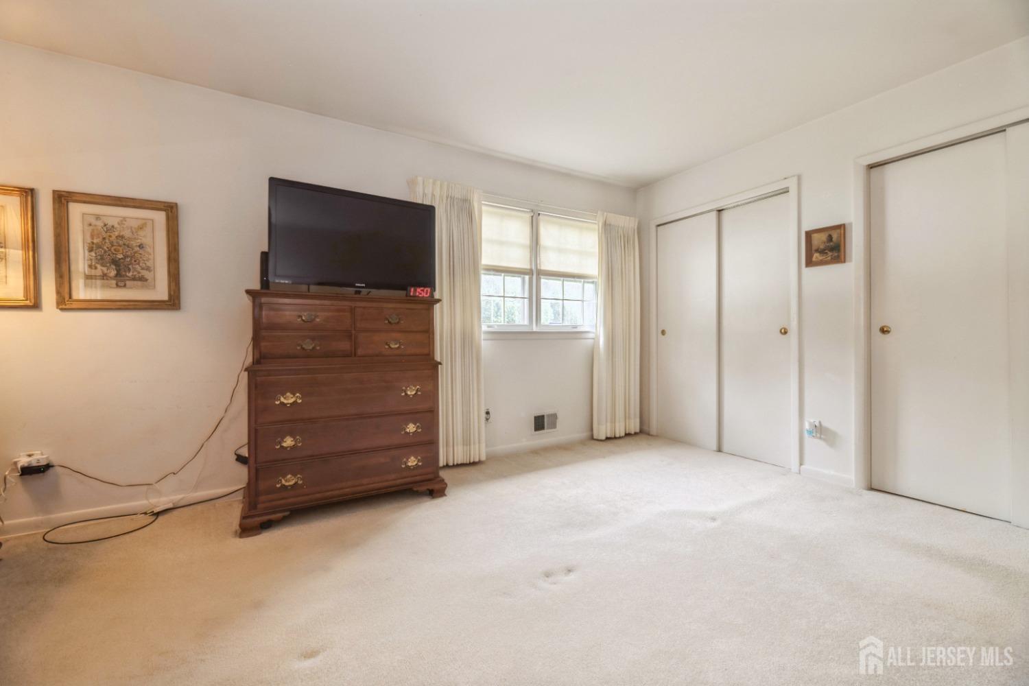 295 Dallas Road North Brunswick, NJ 08902 - Photo 22 of 40 a view of an empty room with window and cabinet