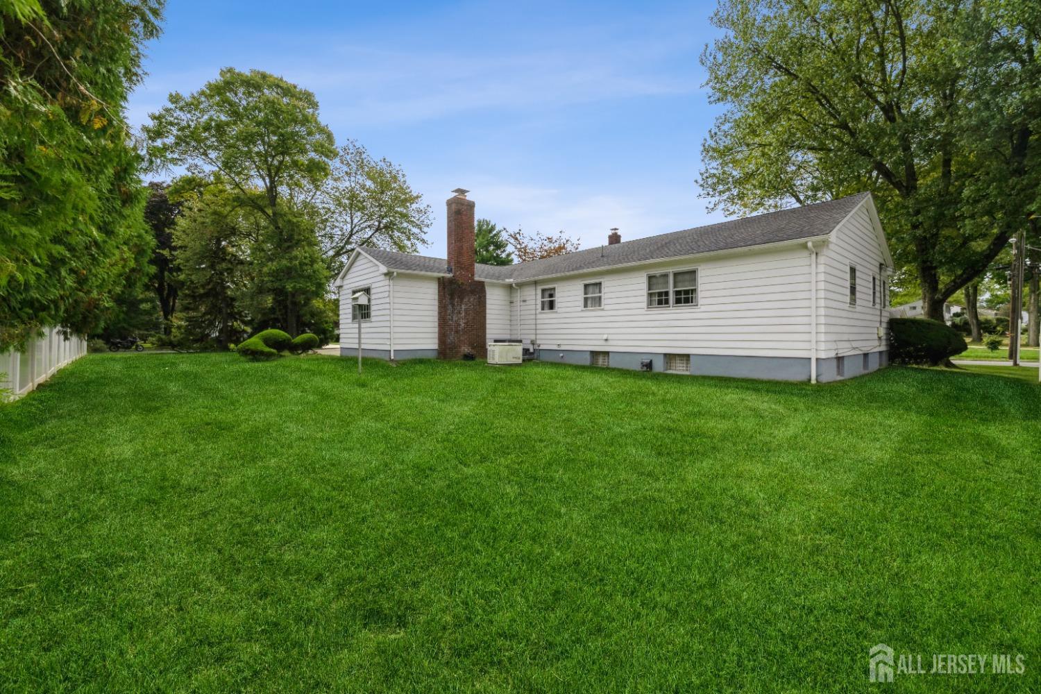 295 Dallas Road North Brunswick, NJ 08902 - Photo 33 of 40 a view of a house with a yard and a large tree