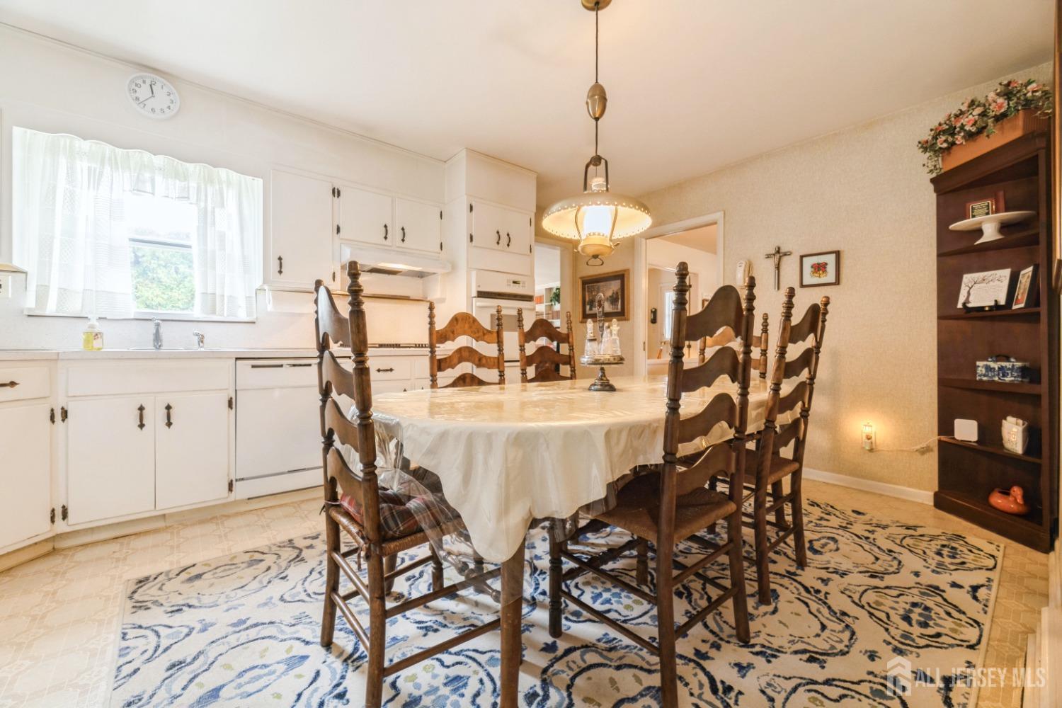 295 Dallas Road North Brunswick, NJ 08902 - Photo 8 of 40 a view of a dining room and livingroom with furniture wooden floor a rug a painting and a chandelier