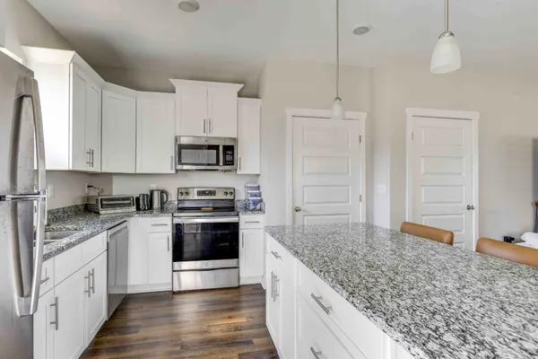 a kitchen with stainless steel appliances granite countertop a stove and a sink
