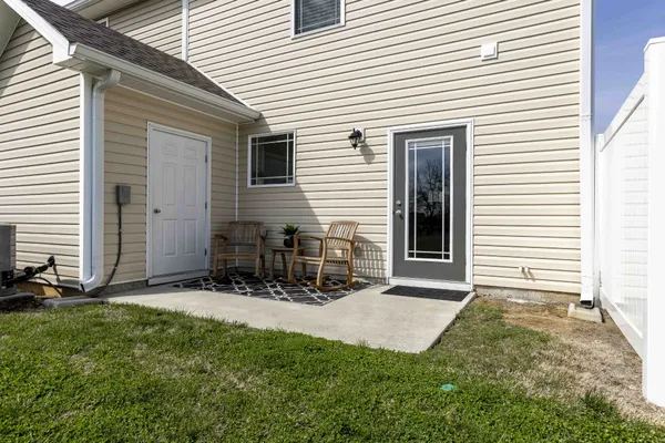 a view of a house with yard and sitting area