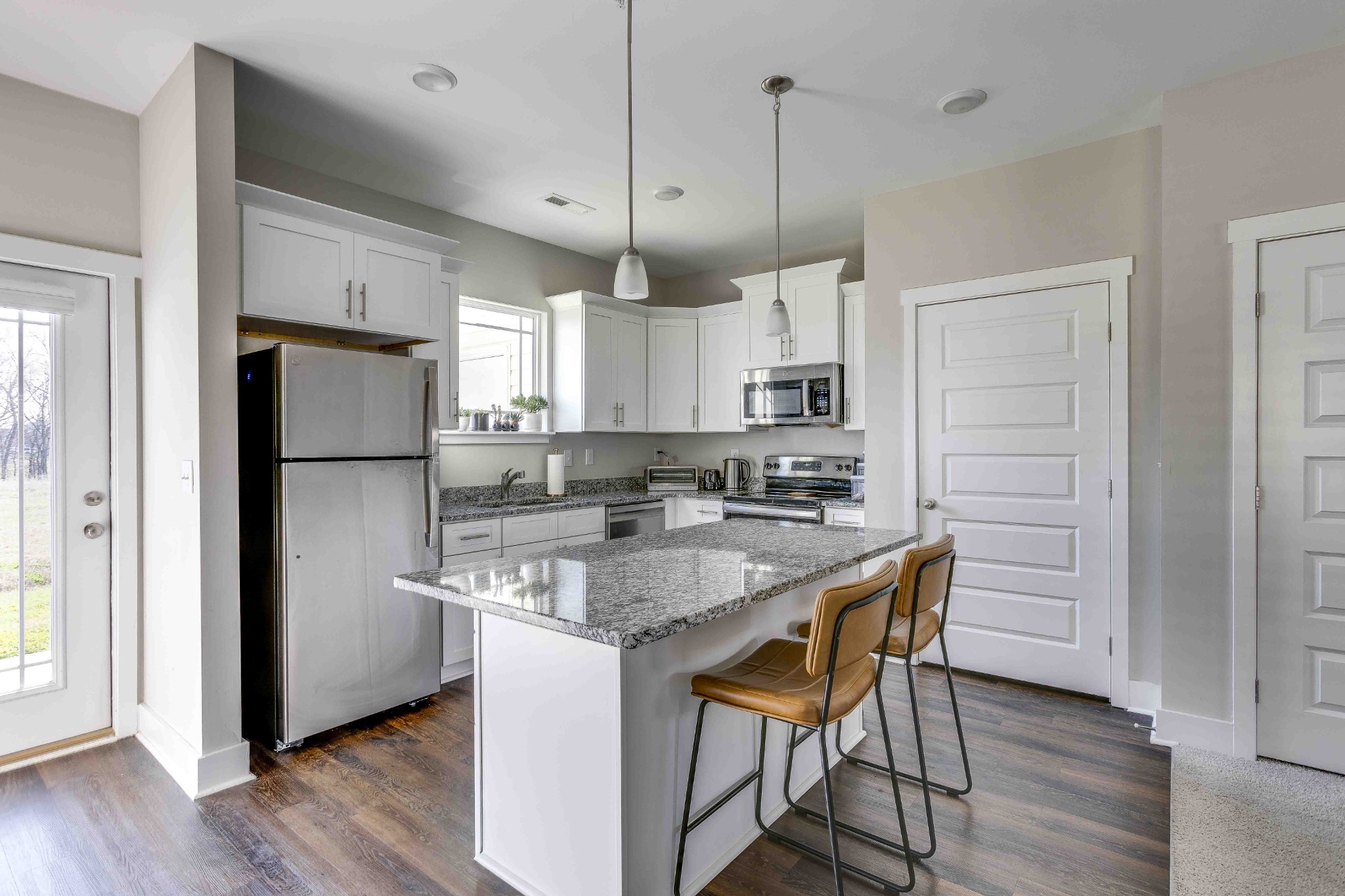 1061 Wells Way Spring Hill, TN 37174 - Photo 9 of 21 a kitchen with stainless steel appliances granite countertop a refrigerator a sink dishwasher a stove a refrigerator and white cabinets with wooden floor