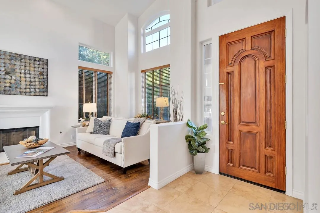 1731 Olivenhain Road Encinitas, CA 92024 - Photo 3 of 31 a living room with furniture a fireplace and a window