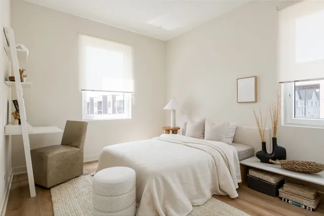 a bedroom with a bed and wooden floor