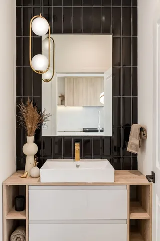 a kitchen with stainless steel appliances kitchen island granite countertop a sink a stove and a wooden floors