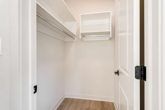 a bedroom with bed and wooden floor