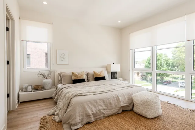a living room with furniture and a floor to ceiling window