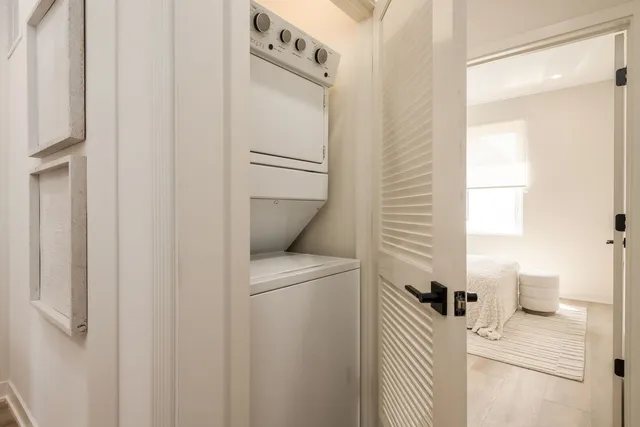 a bedroom with bed and wooden floor