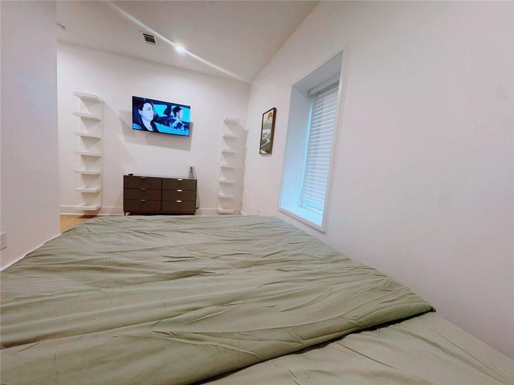 Undisclosed Address Brookhaven, GA 30319 - Photo 16 of 29 a bedroom with a bed and wall painting