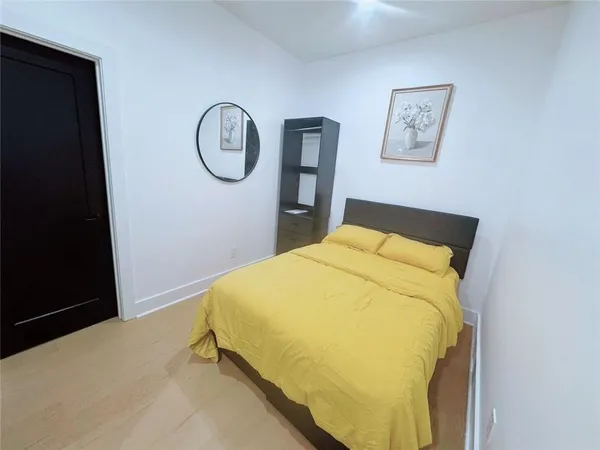 a bedroom with a bed and a night stand