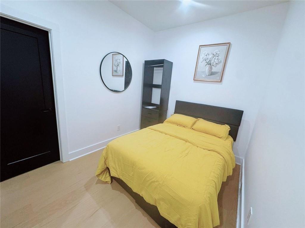 Undisclosed Address Brookhaven, GA 30319 - Photo 17 of 29 a bed sitting in a bedroom with a mirror