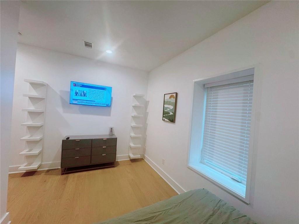 Undisclosed Address Brookhaven, GA 30319 - Photo 20 of 29 a view of empty room with wooden floor