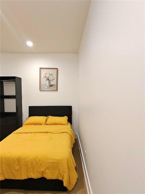 Undisclosed Address Brookhaven, GA 30319 - Photo 23 of 29 a bed sitting in a bedroom and a mirror