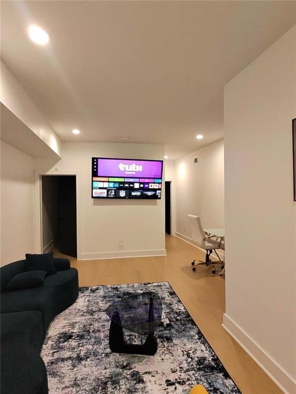 Undisclosed Address Brookhaven, GA 30319 - Photo 26 of 29 a living room with furniture and a flat screen tv