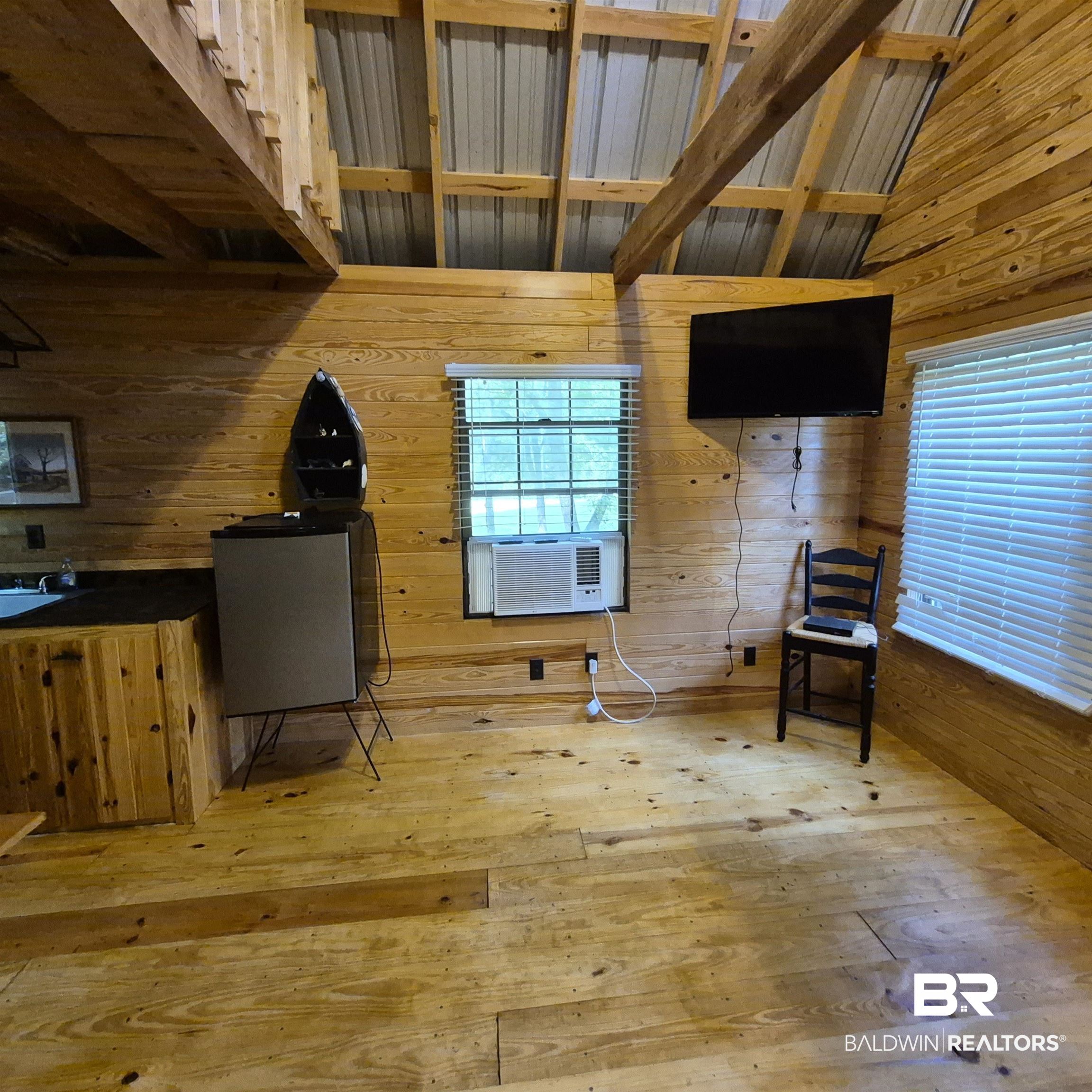 0 Eureka Landing Road Uriah, AL 36480 - Photo 9 of 27 Wood-paneled interior featuring natural wood-finish flooring, exposed wood beams, and a corrugated metal ceiling