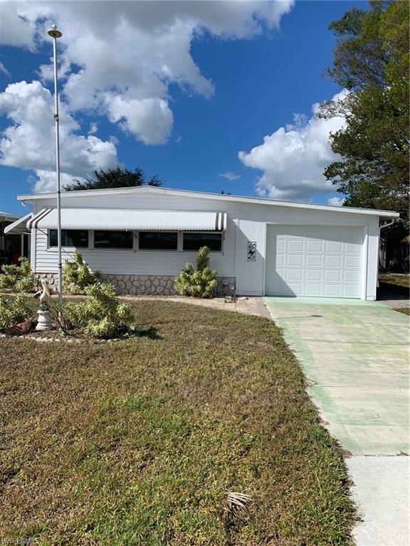 9322 Pitt Road Bonita Springs, FL 34135 - Photo 1 of 24 a front view of a house with a yard