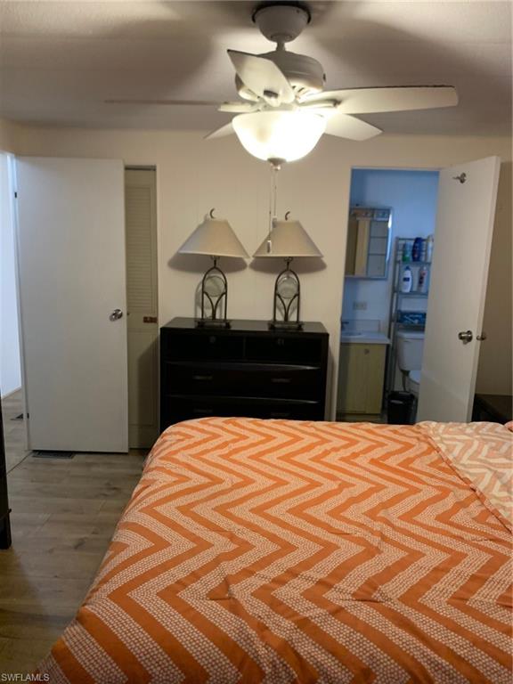 9322 Pitt Road Bonita Springs, FL 34135 - Photo 13 of 24 a bedroom with a bed and wooden floor