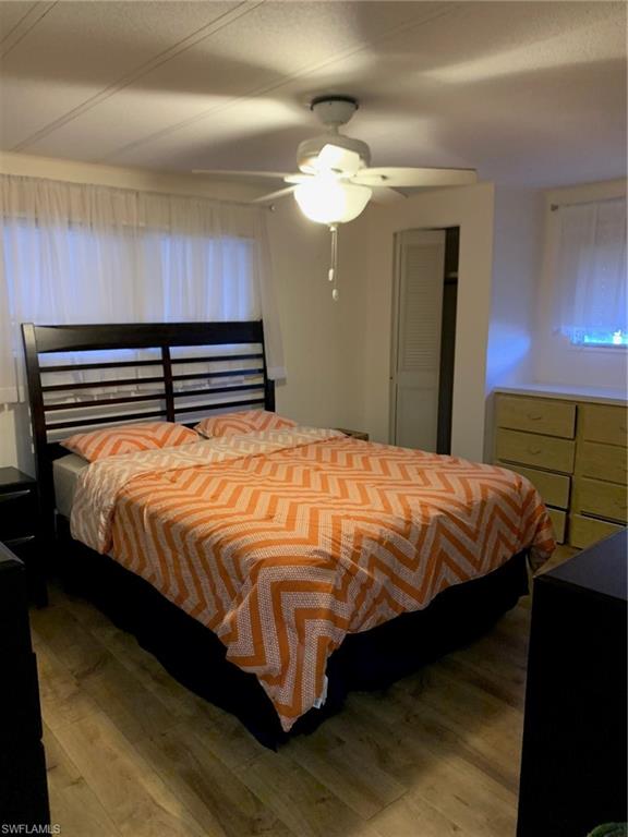 9322 Pitt Road Bonita Springs, FL 34135 - Photo 15 of 24 a bed sitting in a bedroom next to a lamp