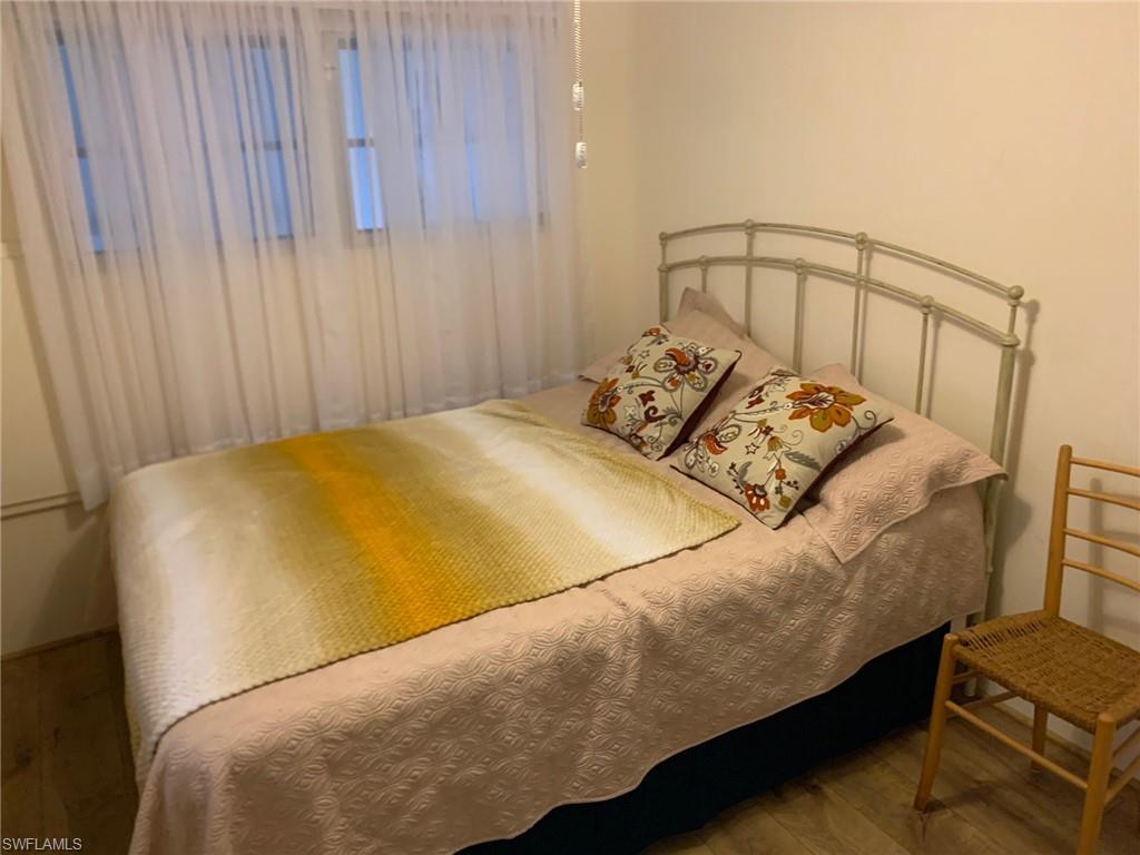 9322 Pitt Road Bonita Springs, FL 34135 - Photo 16 of 24 a bed sitting in a bedroom next to a window