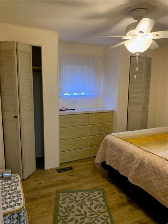 9322 Pitt Road Bonita Springs, FL 34135 - Photo 17 of 24 a bedroom with a bed and a chandelier