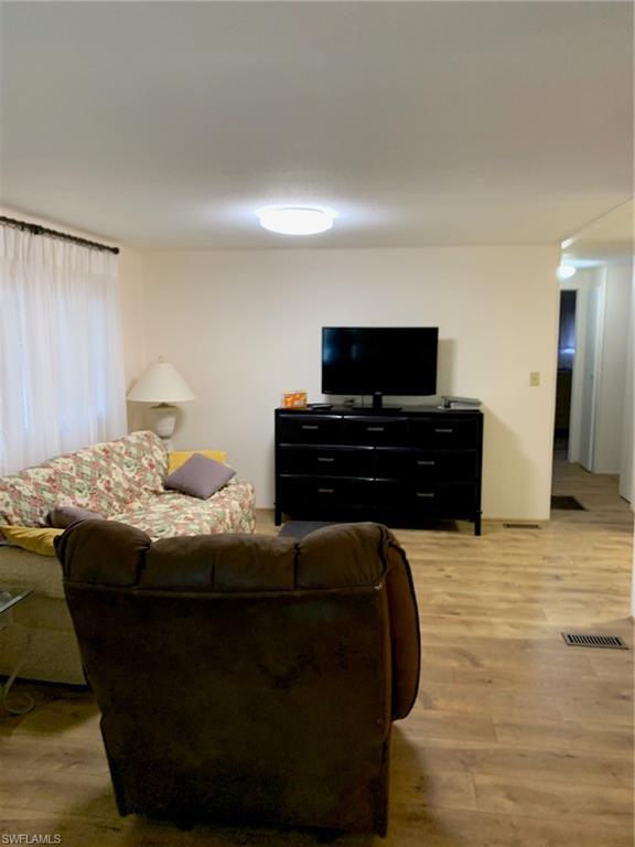 9322 Pitt Road Bonita Springs, FL 34135 - Photo 20 of 24 a bedroom with a bed and a flat screen tv